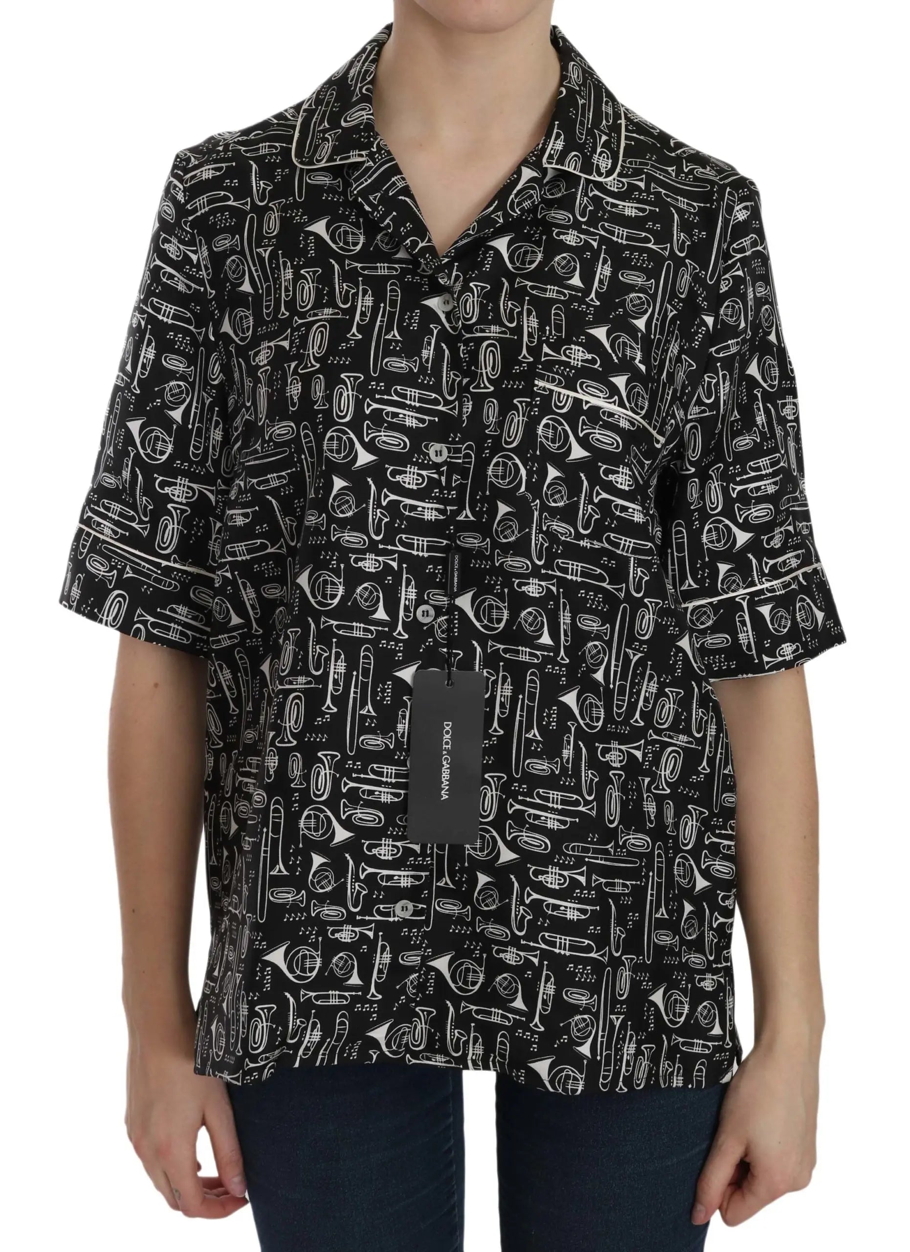 Black short-sleeve silk blouse with white musical instrument print and notched collar.