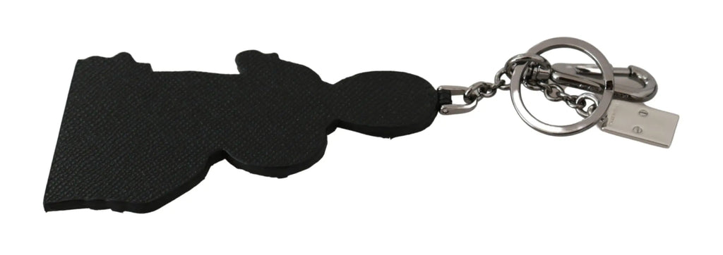 Leather keychain with two cartoon figures wearing glasses and a red camera accessory on a brass chain and clasp.