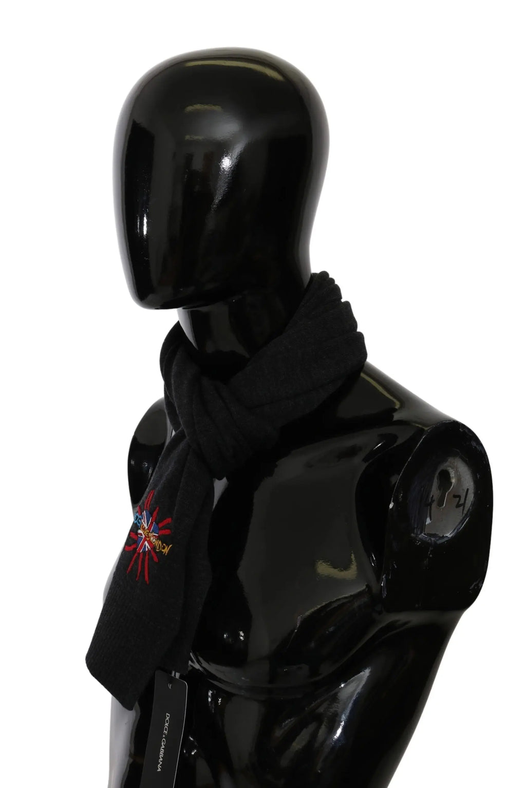 Gray wool scarf with embroidered multicolor starburst detail on black mannequin bust.