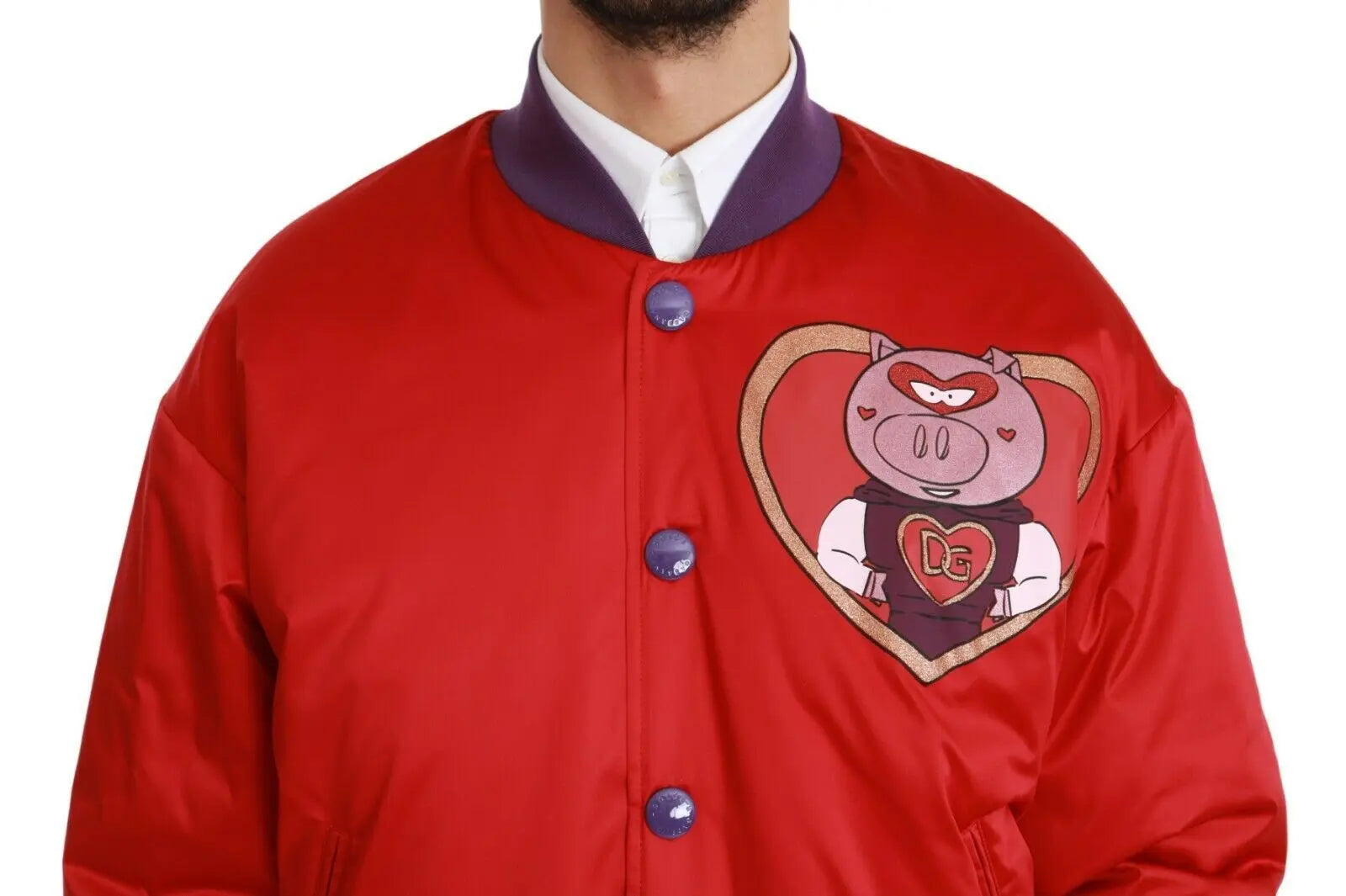 Red bomber jacket with purple ribbed cuffs and hem, featuring a pig emblem patch on the chest and blue snap buttons.