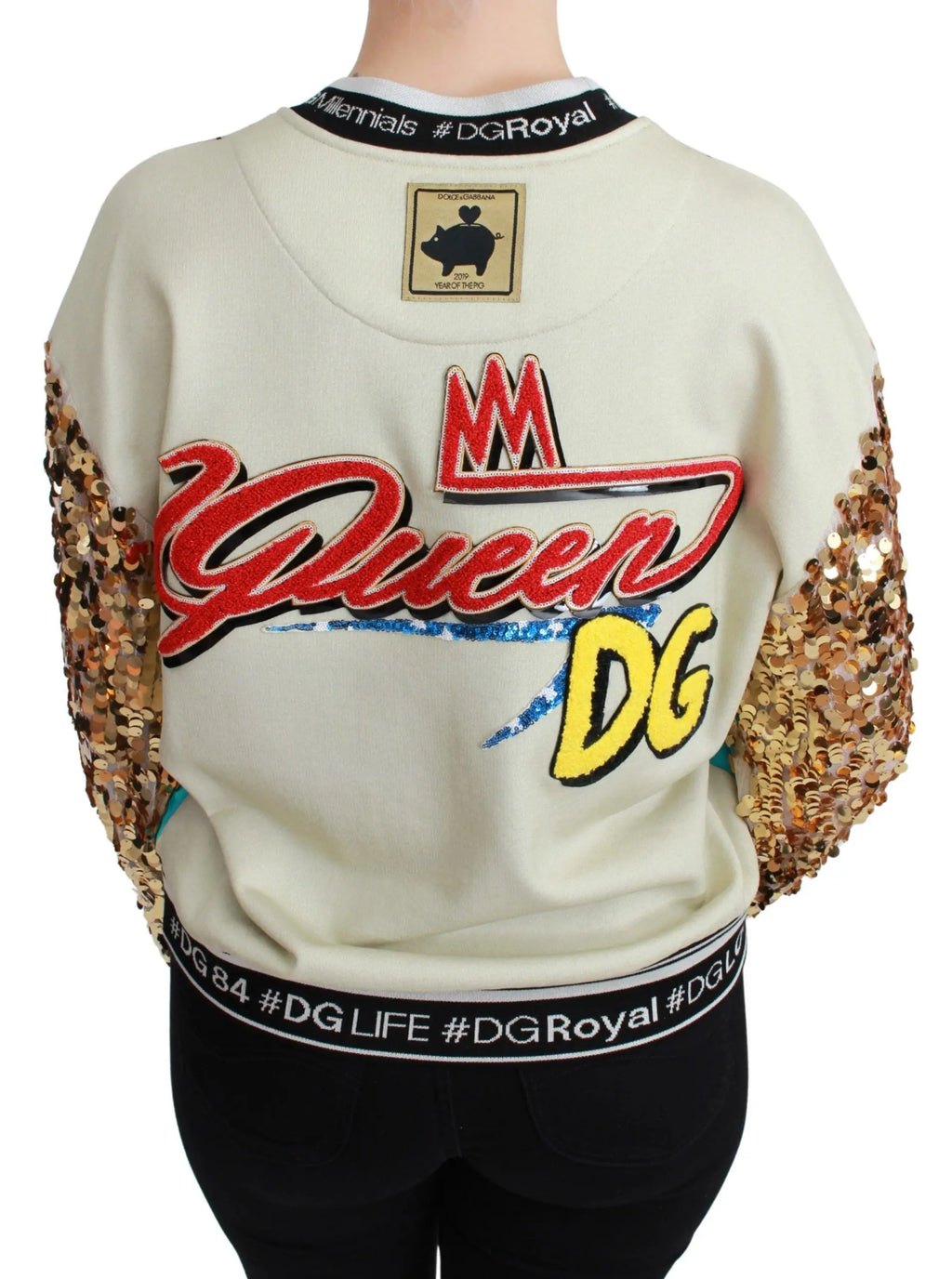 Multicolor sequined sweater with cartoon pig design, gold sequin sleeves, and black logo cuffs.