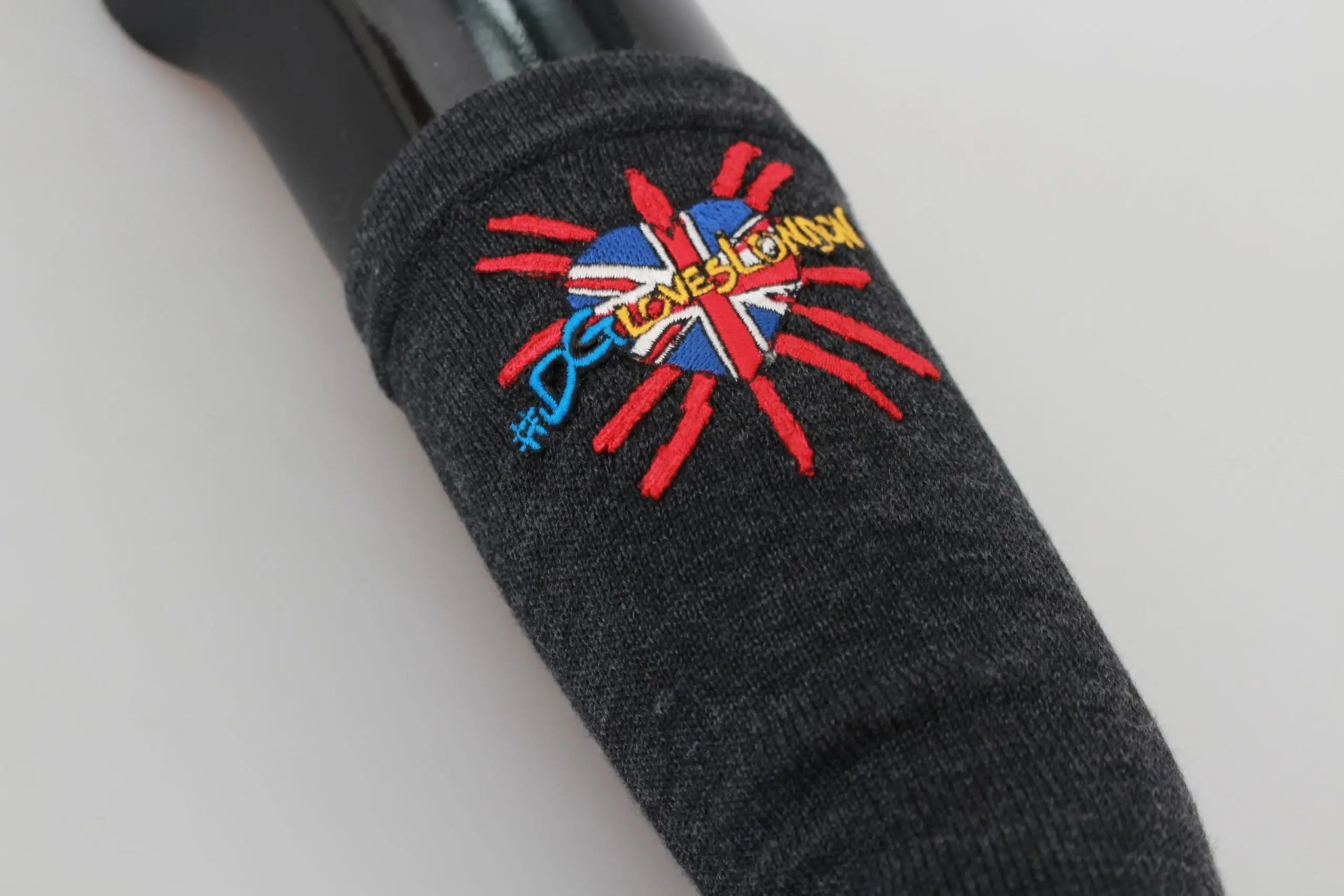 Gray long virgin wool gloves with colorful embroidered floral detail on wrist.