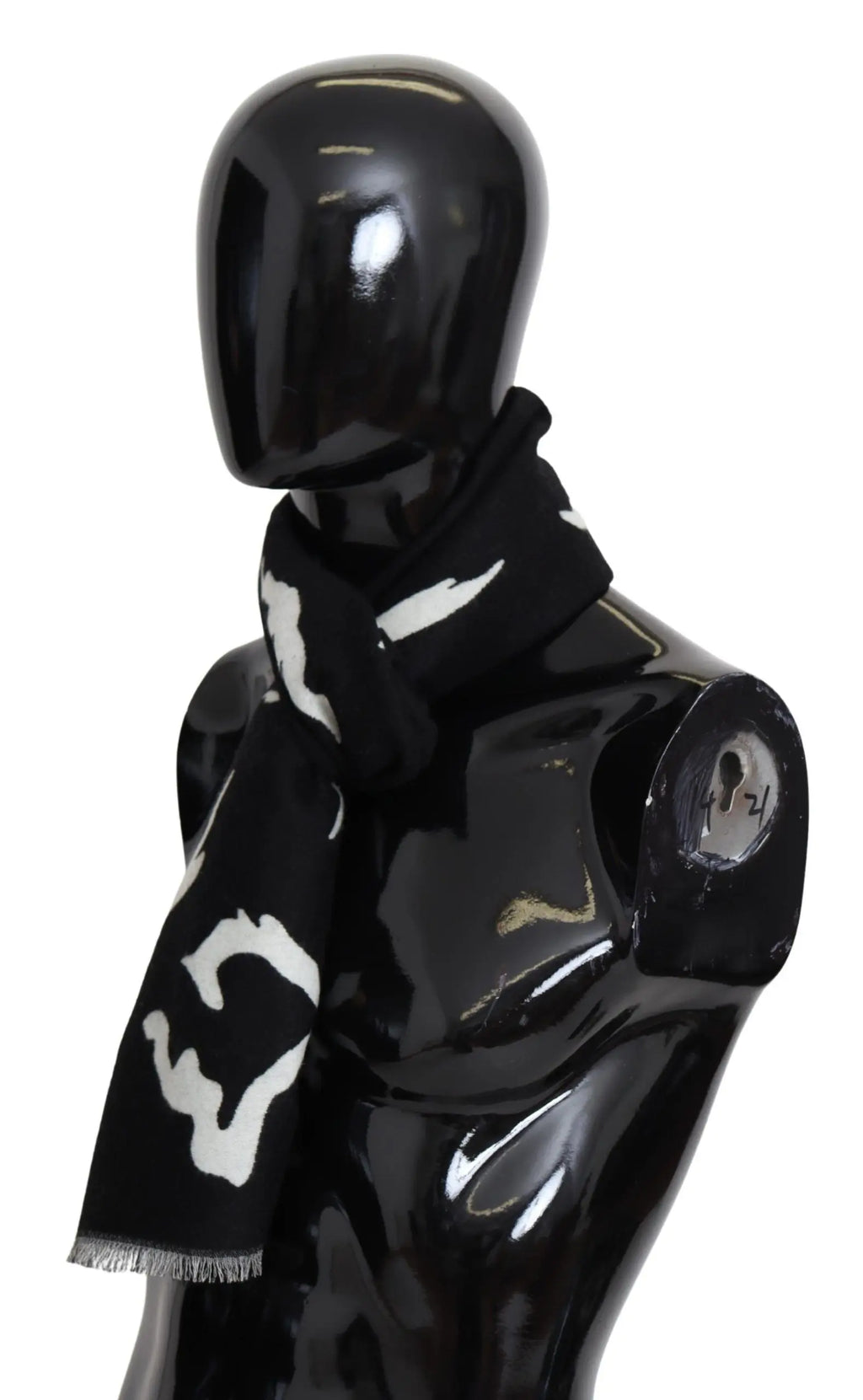 Black and white wool scarf with abstract pattern, fringed ends, styled around mannequin neck.