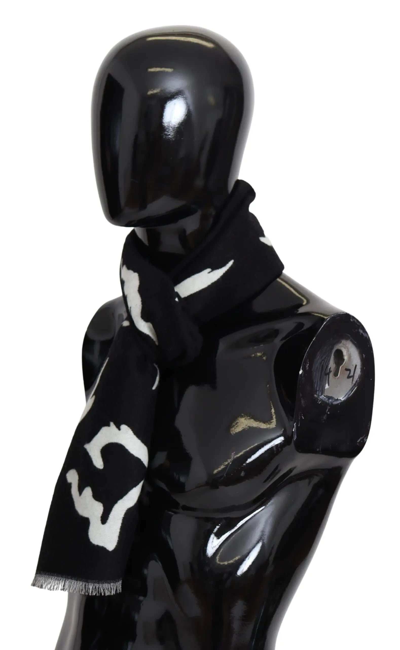 Black and white wool scarf with abstract pattern, fringed ends, styled around mannequin neck.