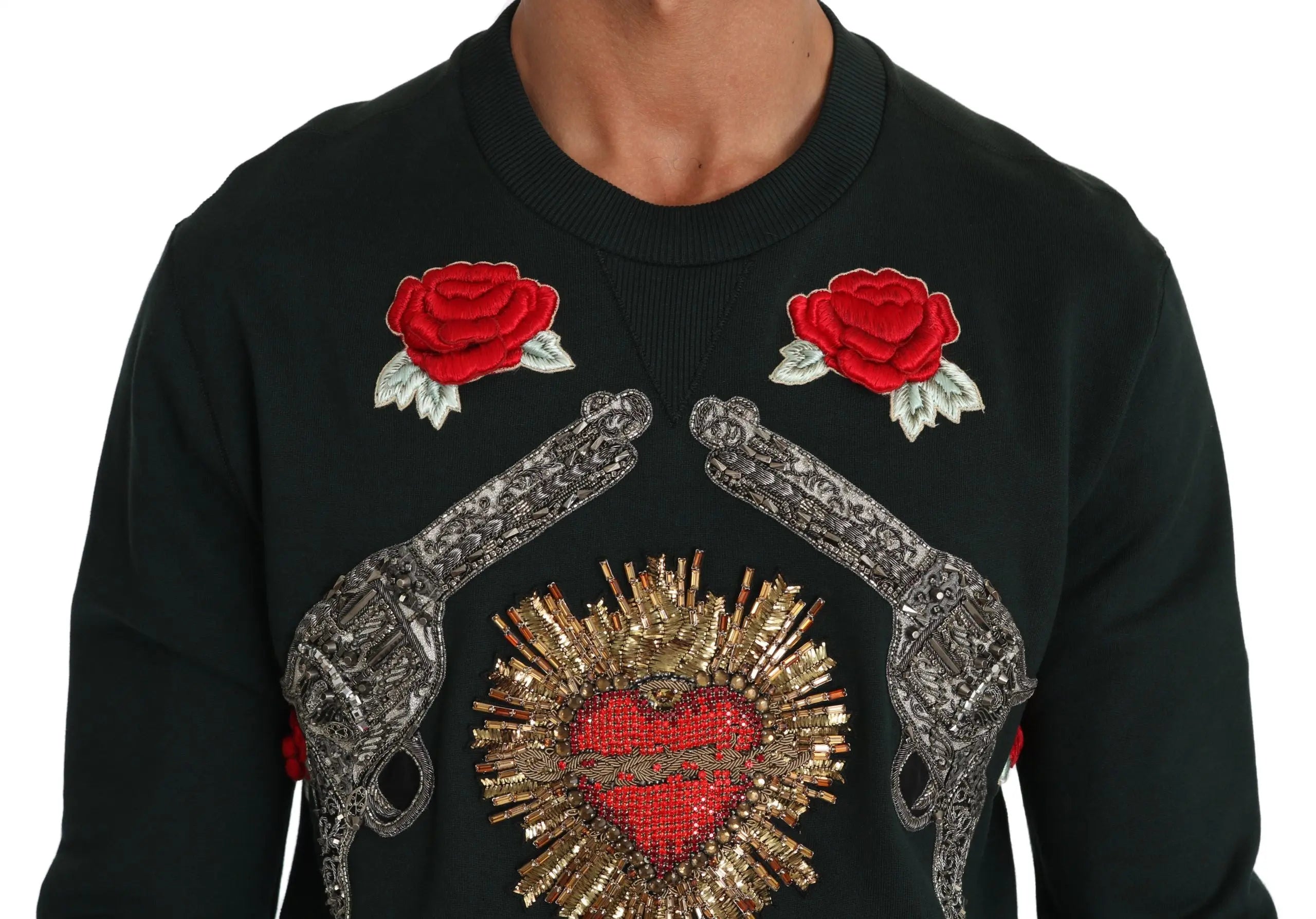 Green crewneck sweater with embroidered crystal heart, roses, and gun motifs.