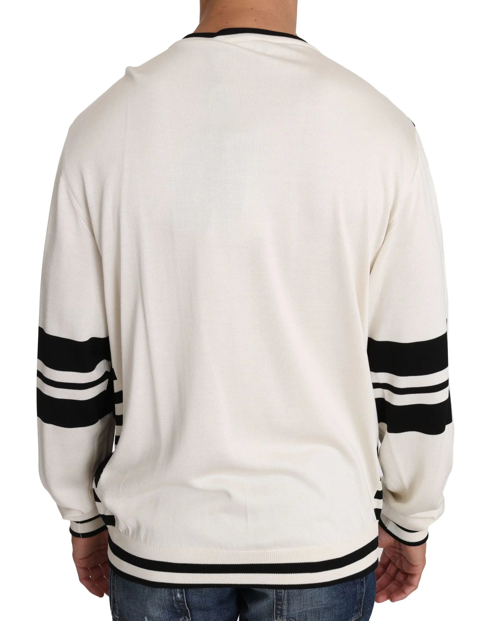 White long-sleeve pullover sweater with black and dark sequined jazz guitar and music note design, black stripes on sleeves.