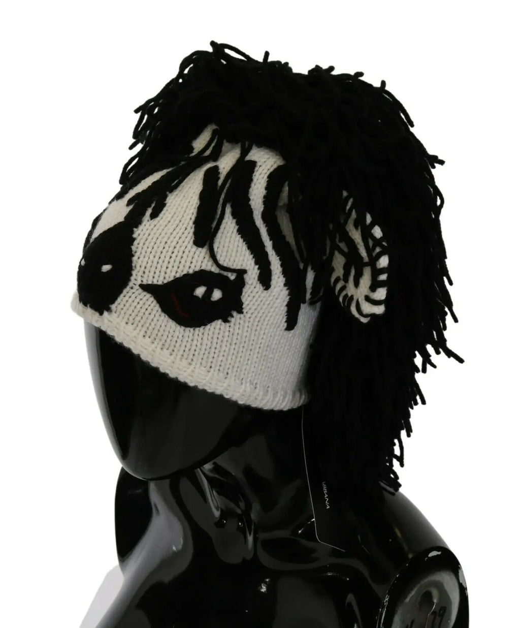 Black and white knitted cashmere beanie with animal face design and black fringe detailing.