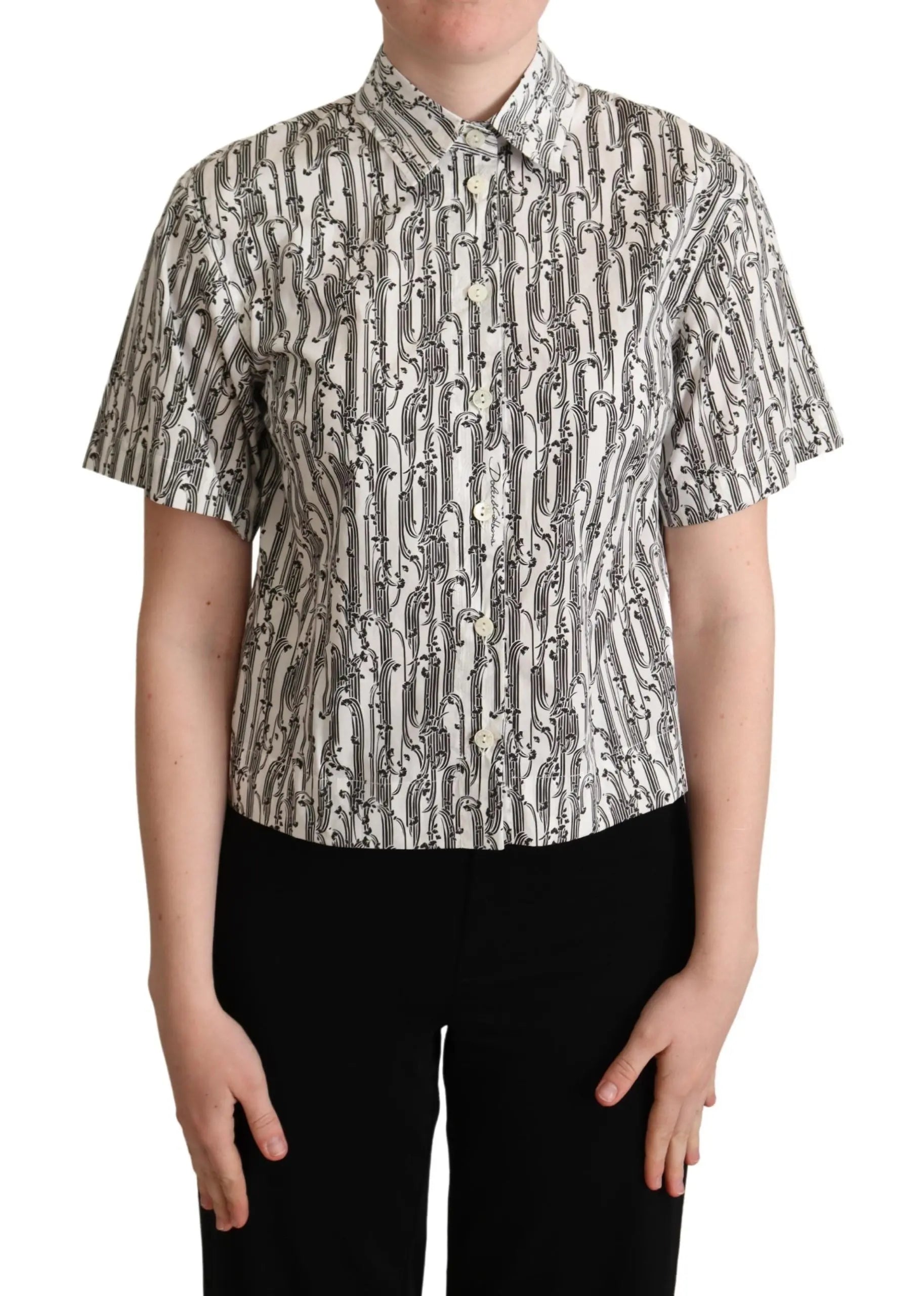 White short-sleeve collared blouse with black abstract floral print, button-down front, fitted cut.