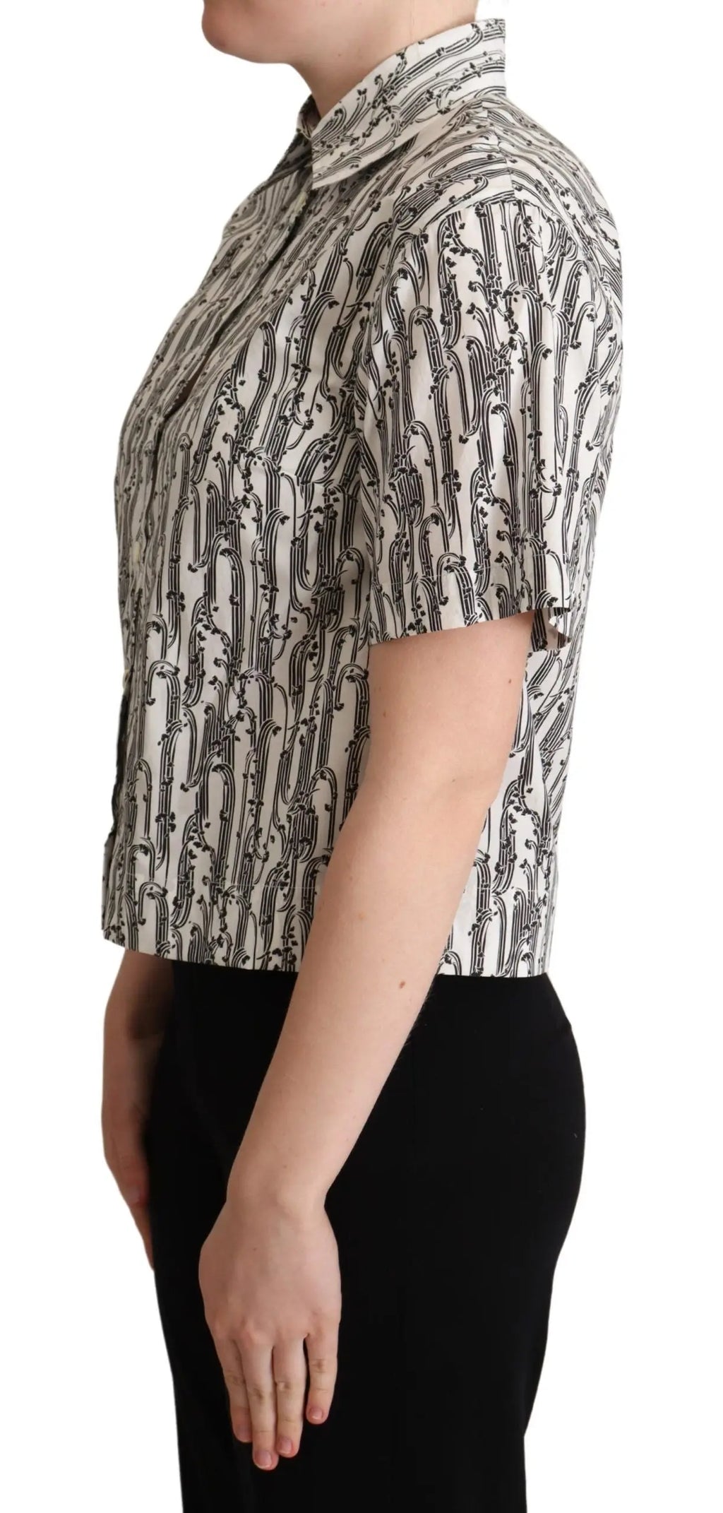 White short-sleeve collared blouse with black abstract floral print, button-down front, fitted cut.