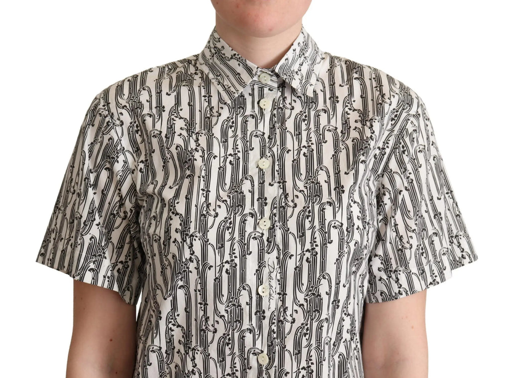 White short-sleeve collared blouse with black abstract floral print, button-down front, fitted cut.