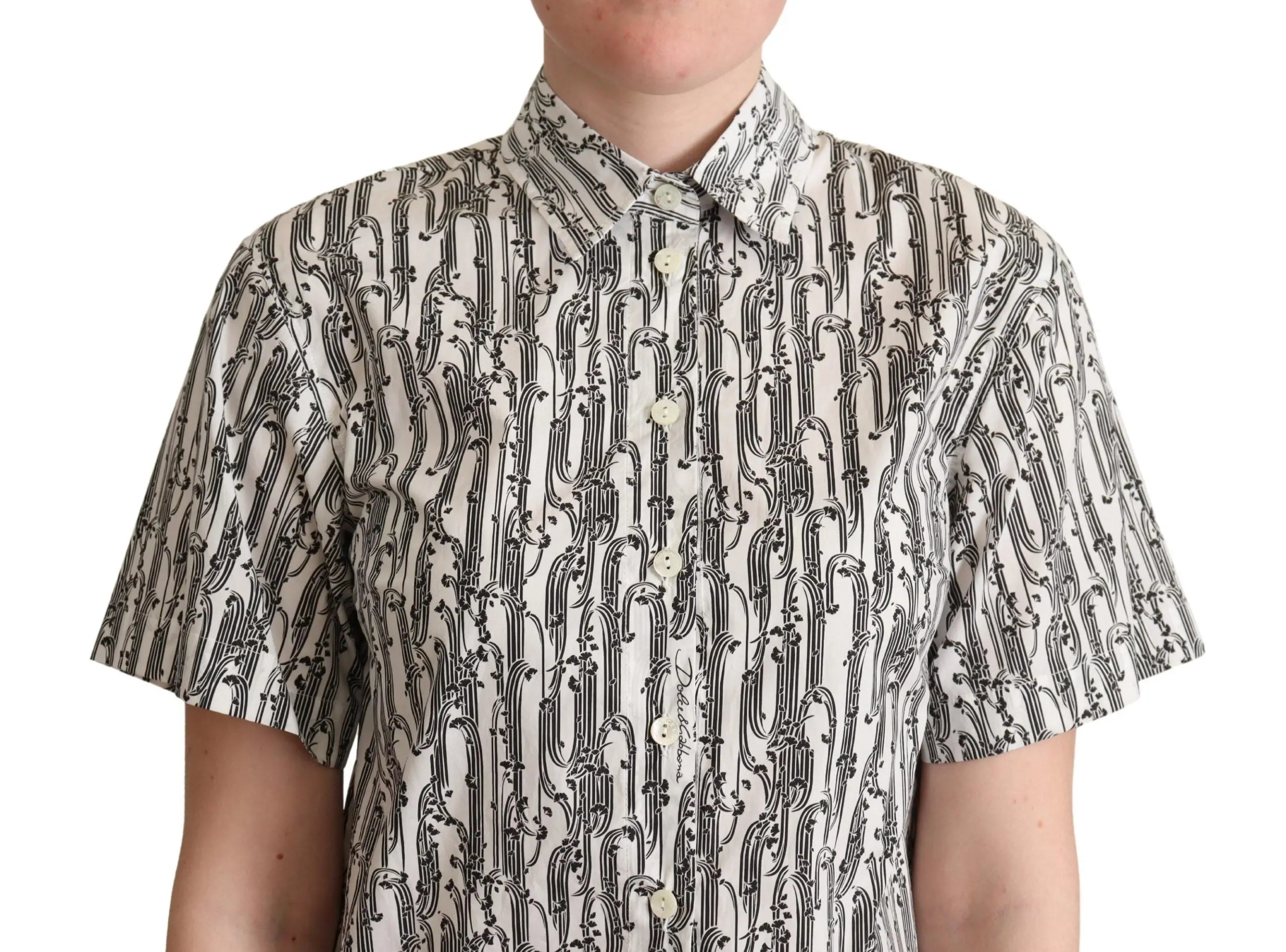 White short-sleeve collared blouse with black abstract floral print, button-down front, fitted cut.