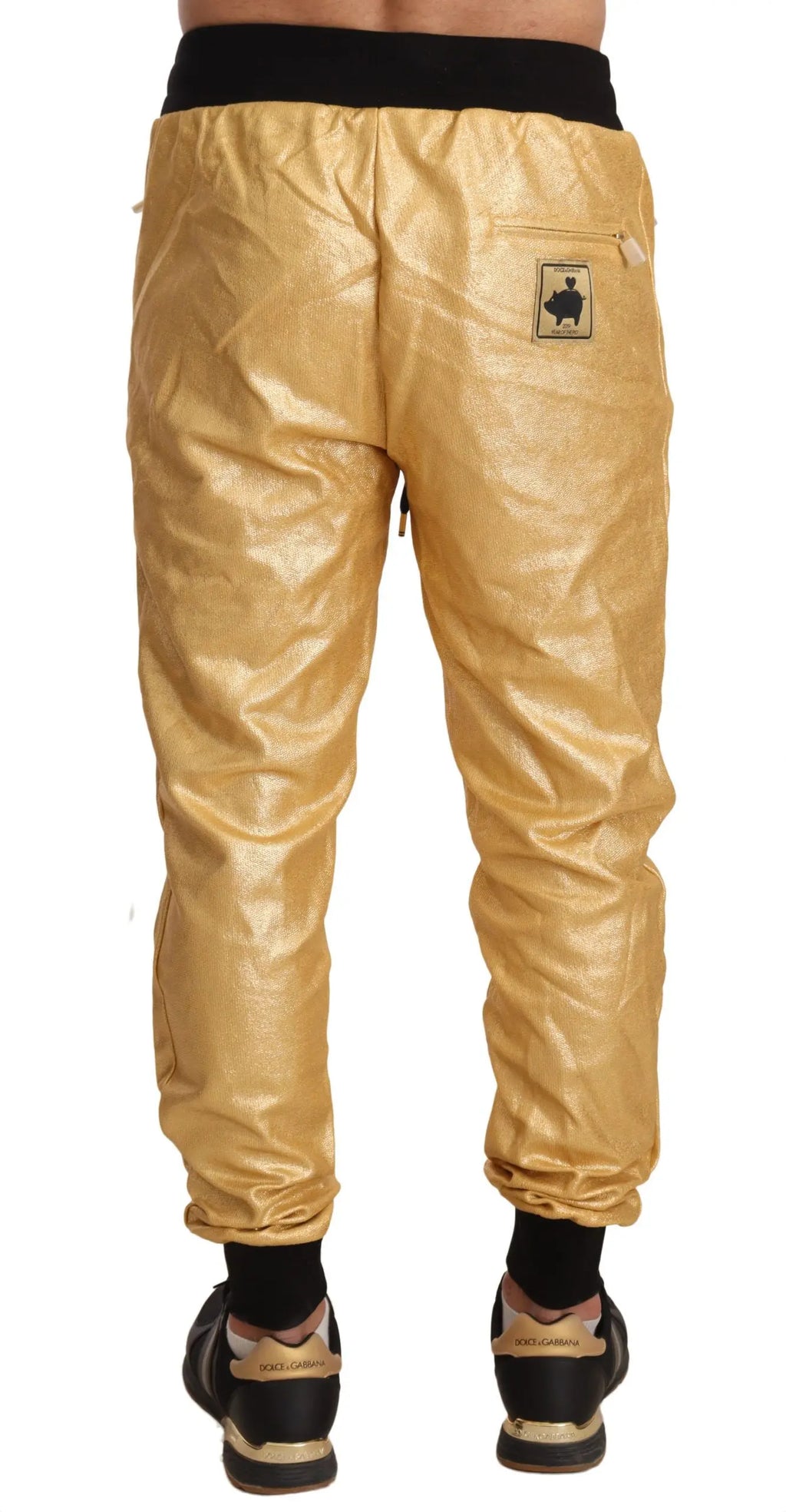 Gold cotton jogger pants with black elastic waistband and cuffs, slim fit design.