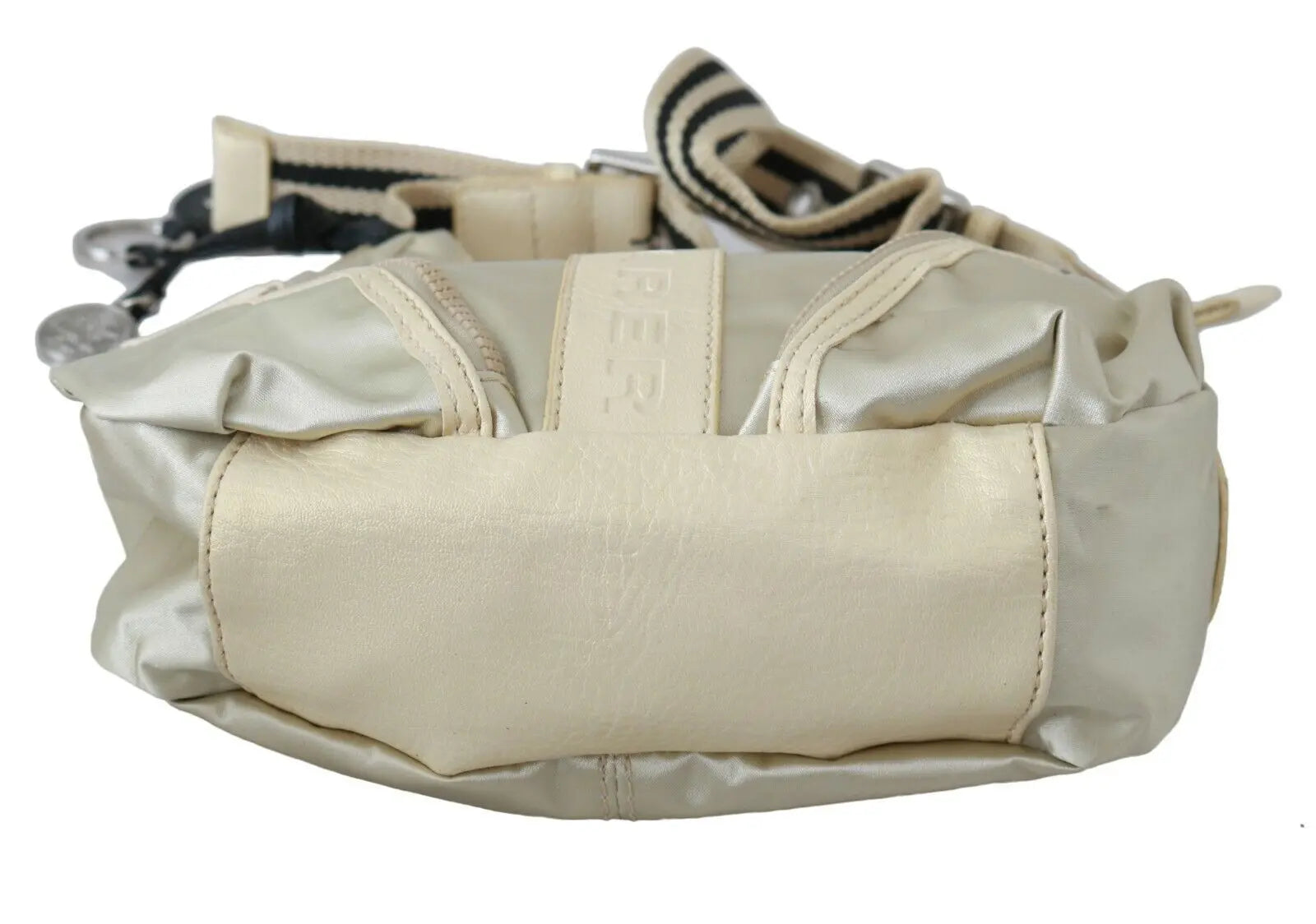 White fabric crossbody sling bag with beige trim and adjustable striped shoulder strap.
