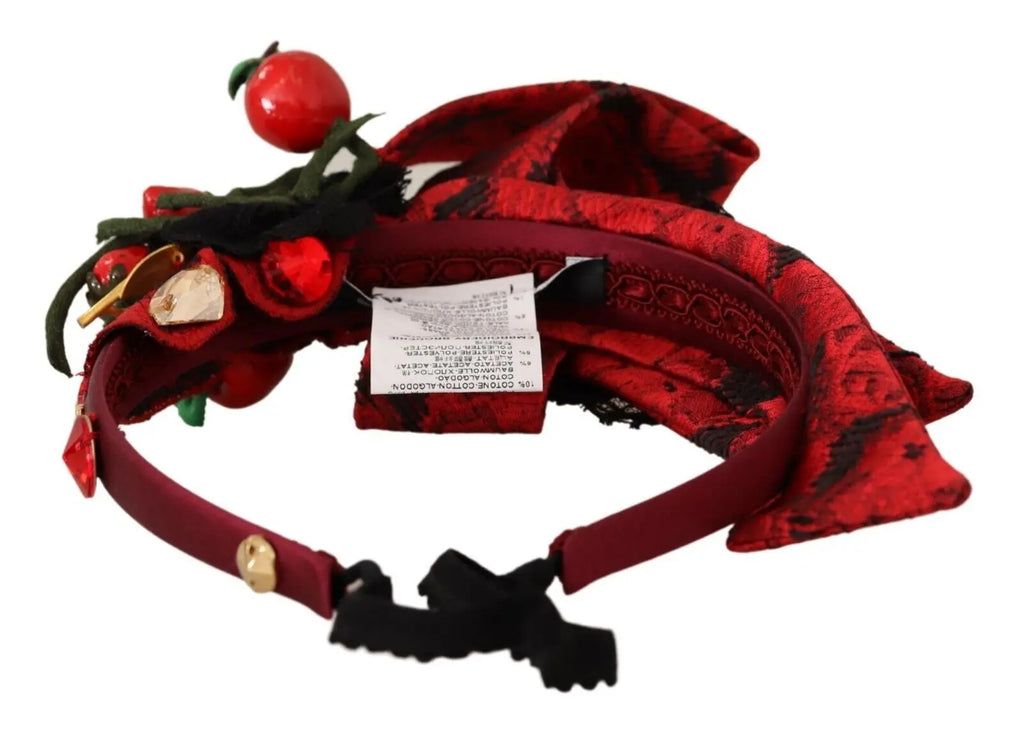Red fabric headband adorned with crystal-embellished berry and bow details.