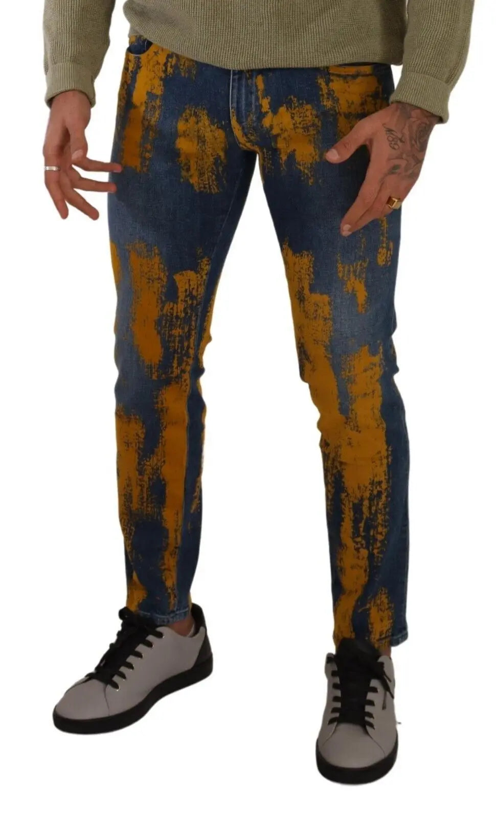 Men’s skinny denim jeans in blue with bold yellow dye splatter, button and zip front closure.