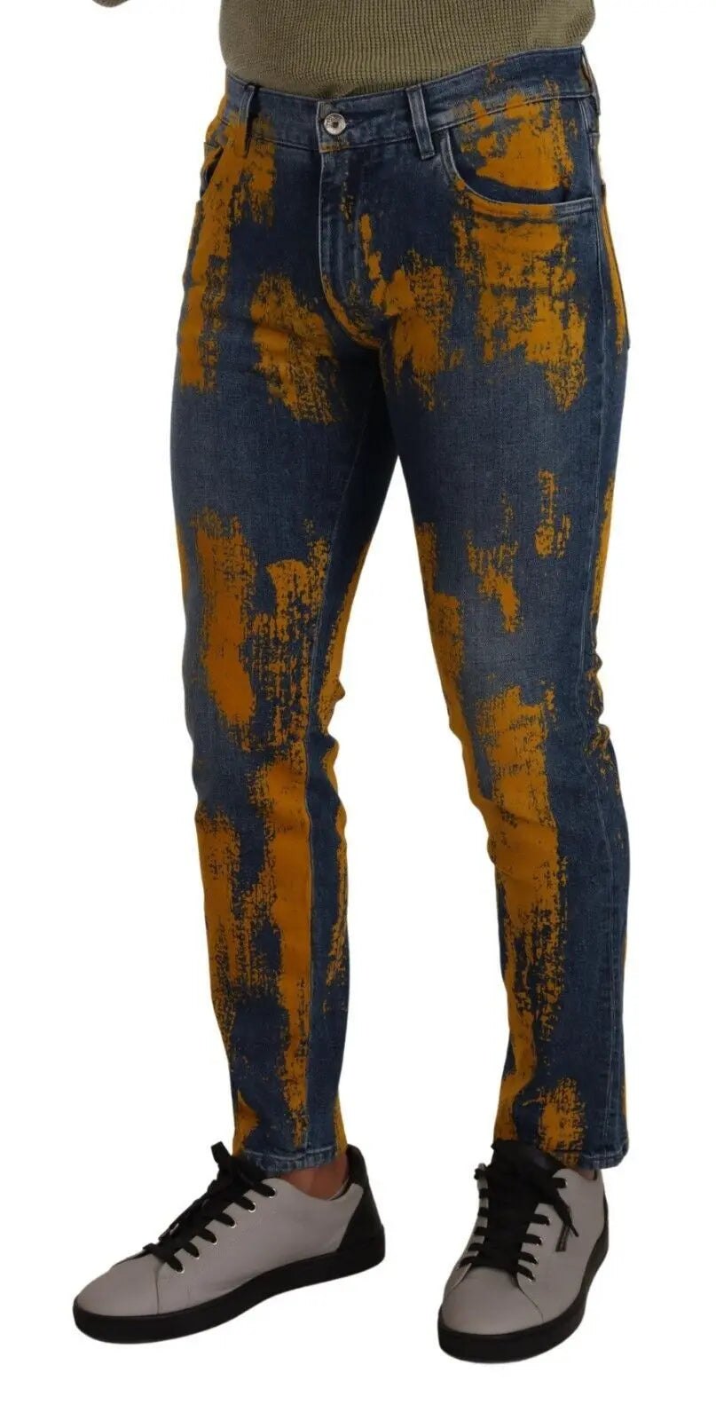 Men’s skinny denim jeans in blue with bold yellow dye splatter, button and zip front closure.