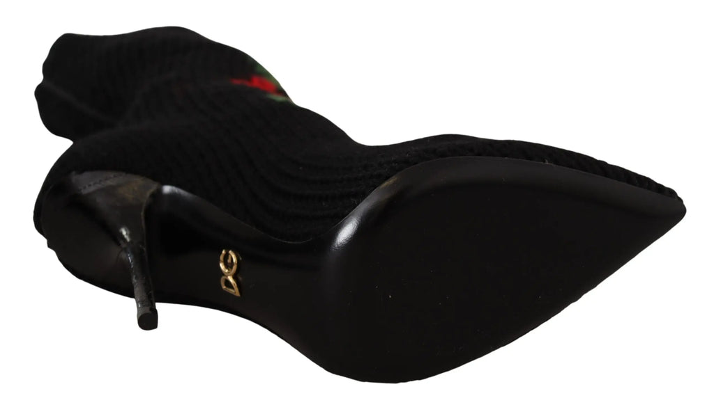 Black high-heeled sock boots with red rose embroidery and pointed toe.