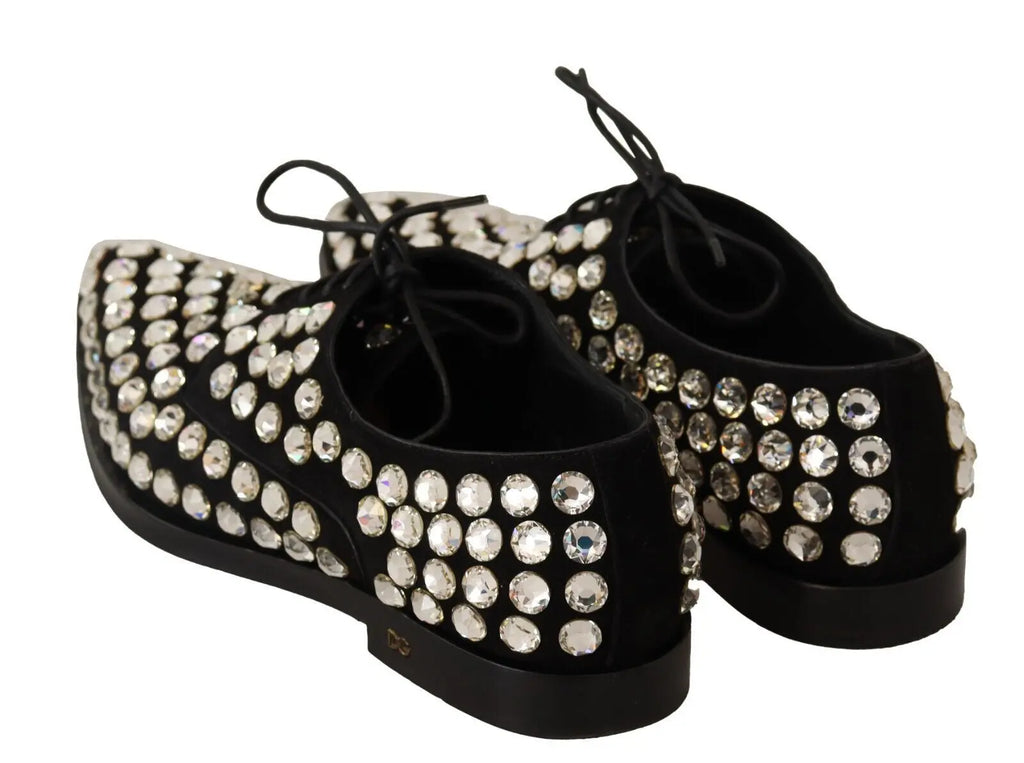 Black leather lace-up Oxford shoe adorned with large round crystals and a low heel.