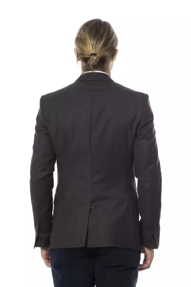 Men's dark gray wool blazer with notch lapels and two-button closure, worn over white dress shirt.