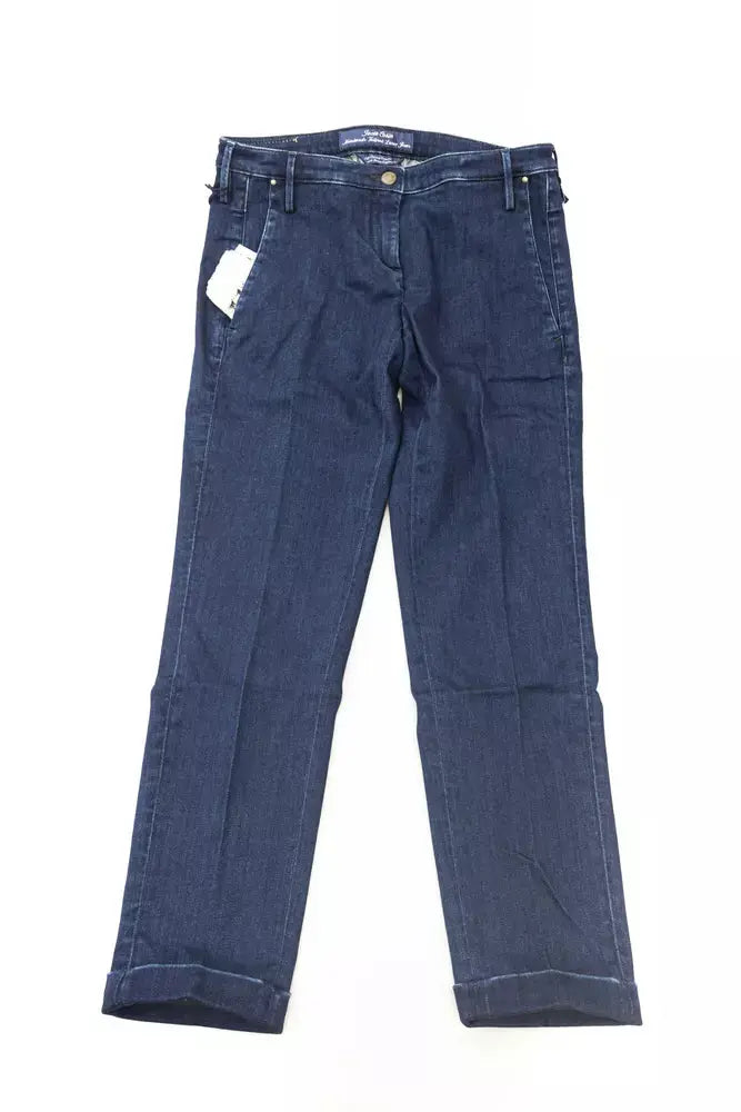 Folded blue cotton women's jeans with classic five-pocket design and white label on waistband.