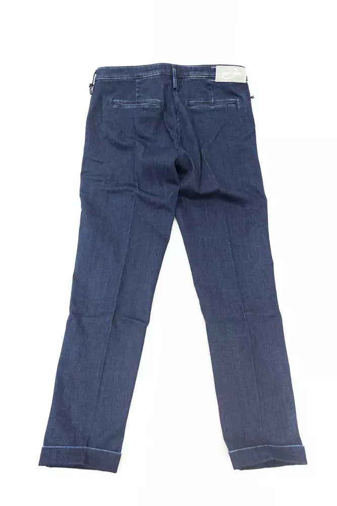 Folded blue cotton women's jeans with classic five-pocket design and white label on waistband.