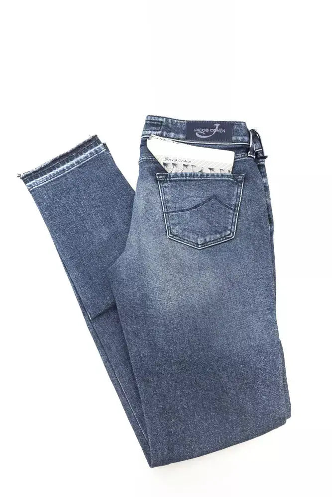 Folded slim fit blue cotton women's jeans with subtle fading and a back pocket patch.