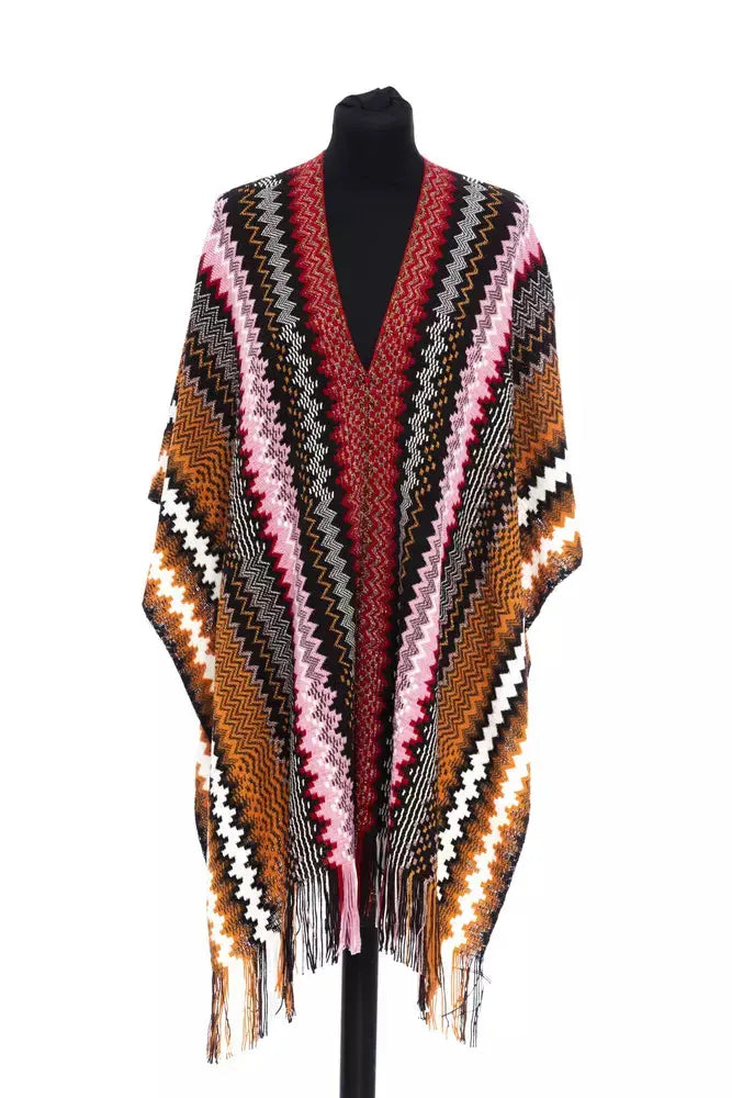 Multicolor wool poncho with zigzag pattern in pink, brown, black, white, and orange, fringed edges.