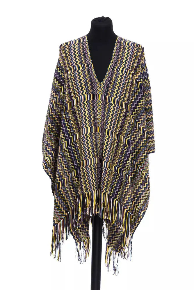 Multicolor wool poncho with zigzag pattern and fringe hem on black mannequin.