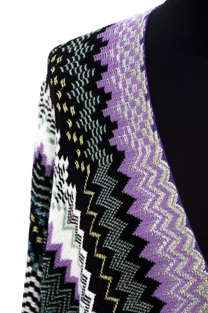 Multicolor wool poncho with chevron pattern in purple, black, green, white, and gray, featuring fringe hem.
