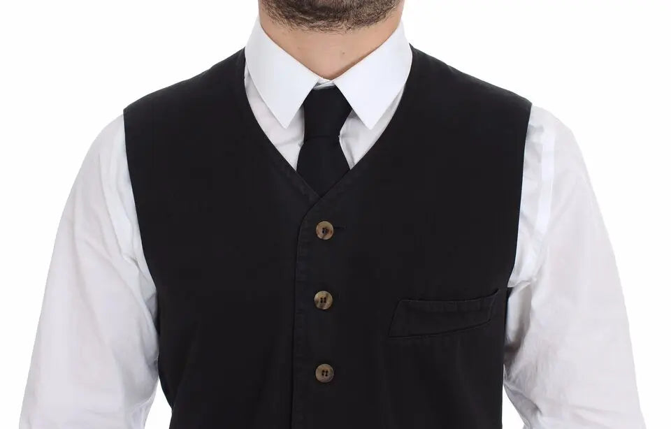 Black cotton viscose dress vest blazer with button front and pointed hem over white dress shirt and black tie.