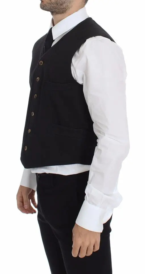 Black cotton viscose dress vest blazer with button front and pointed hem over white dress shirt and black tie.