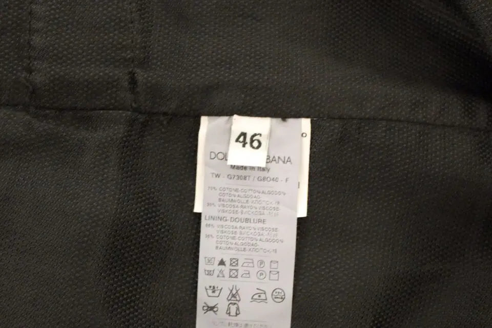 Black cotton viscose dress vest blazer with button front and pointed hem over white dress shirt and black tie.