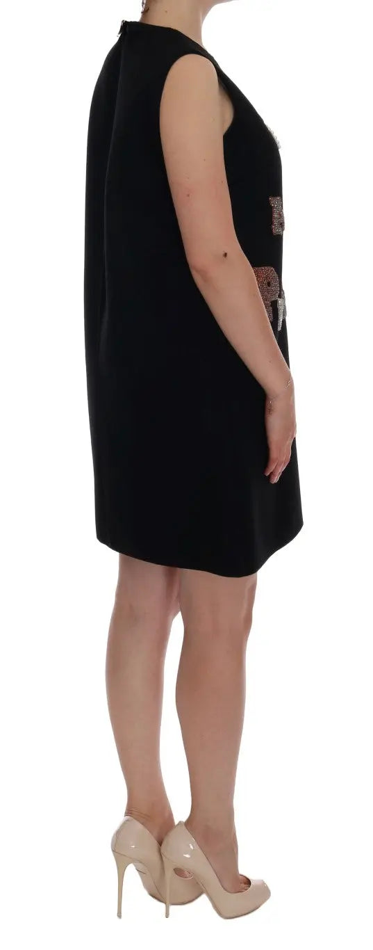 Black sleeveless wool shift dress with "I AM A PRINCESS" crystal embellishments and crown motif.
