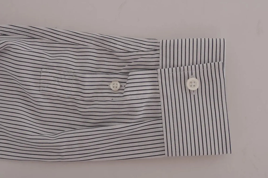 White cotton shirt with thin blue vertical stripes, button-down collar, and long sleeves.