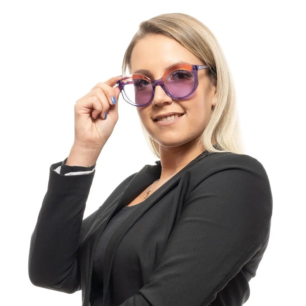 Round purple plastic sunglasses with translucent frames and blue-tinted lenses.