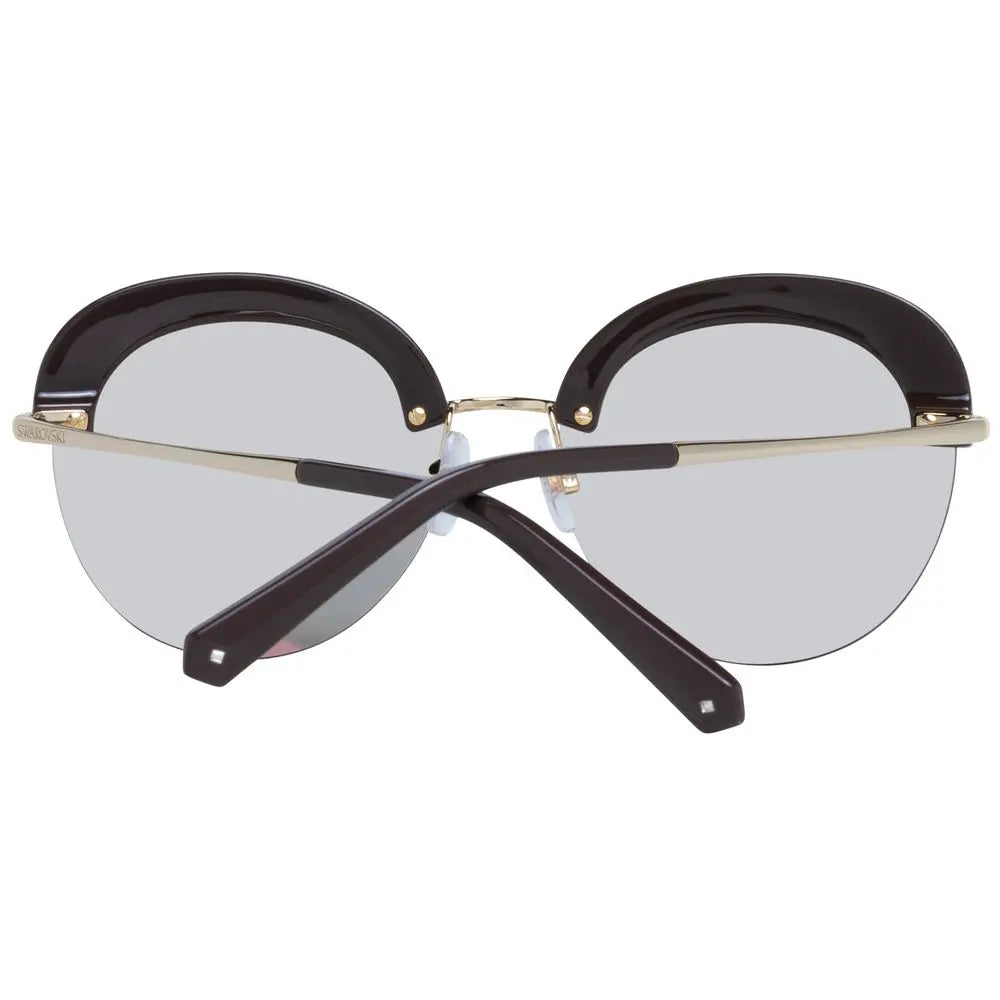 Clear round sunglasses with gold metal frame and black rhinestone-embellished upper rims.