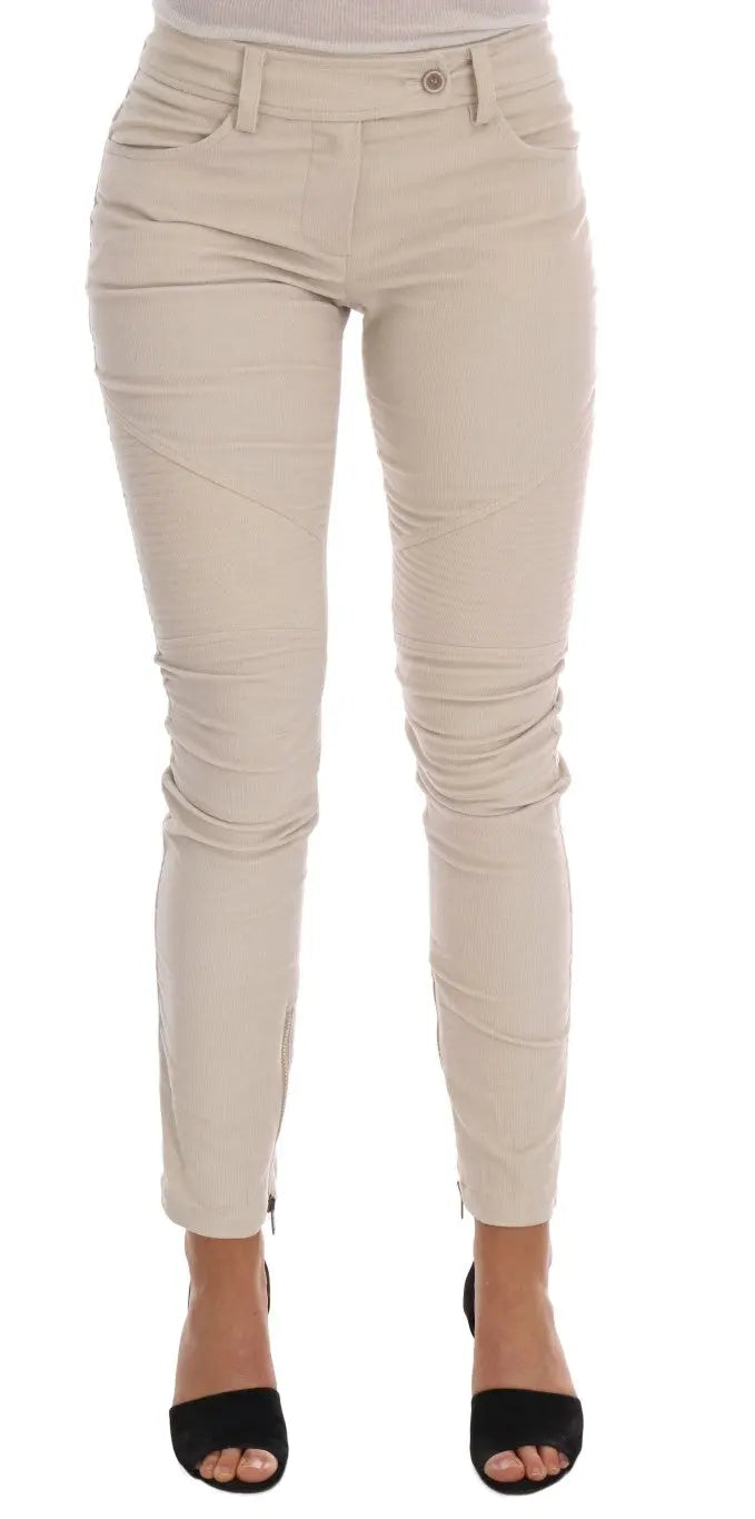 Beige slim-fit corduroy skinny pants with mid-rise waist and front pockets.