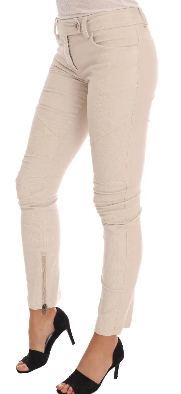 Beige slim-fit corduroy skinny pants with mid-rise waist and front pockets.