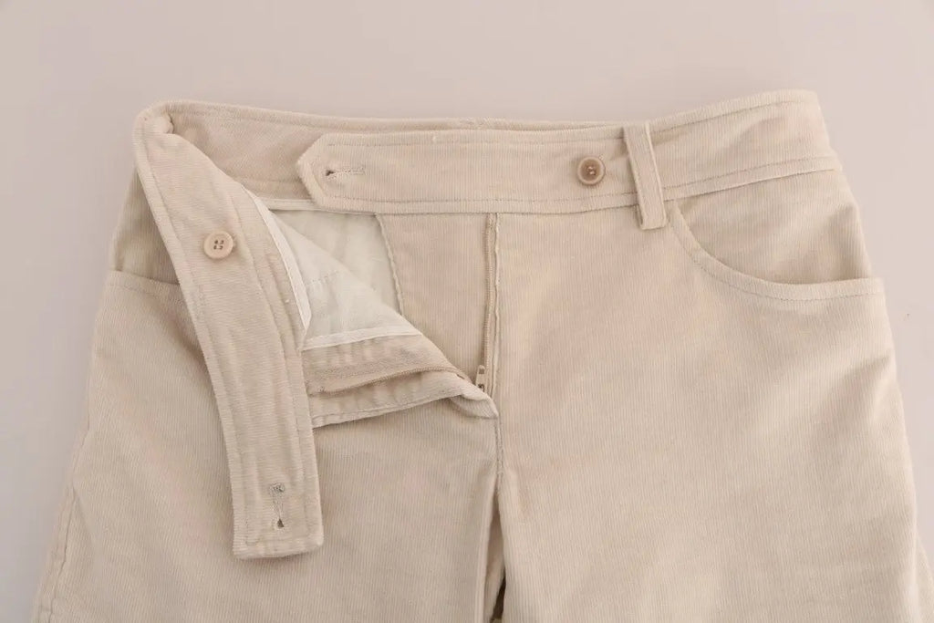 Beige slim-fit corduroy skinny pants with mid-rise waist and front pockets.