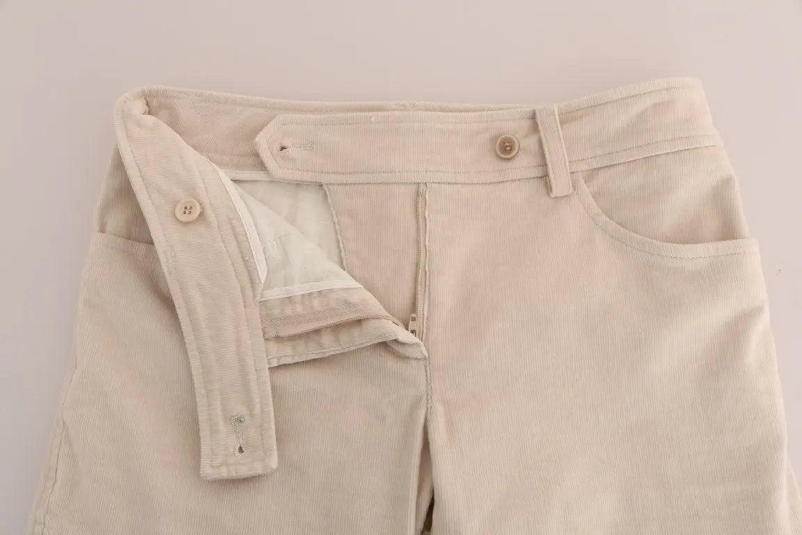 Beige slim-fit corduroy skinny pants with mid-rise waist and front pockets.