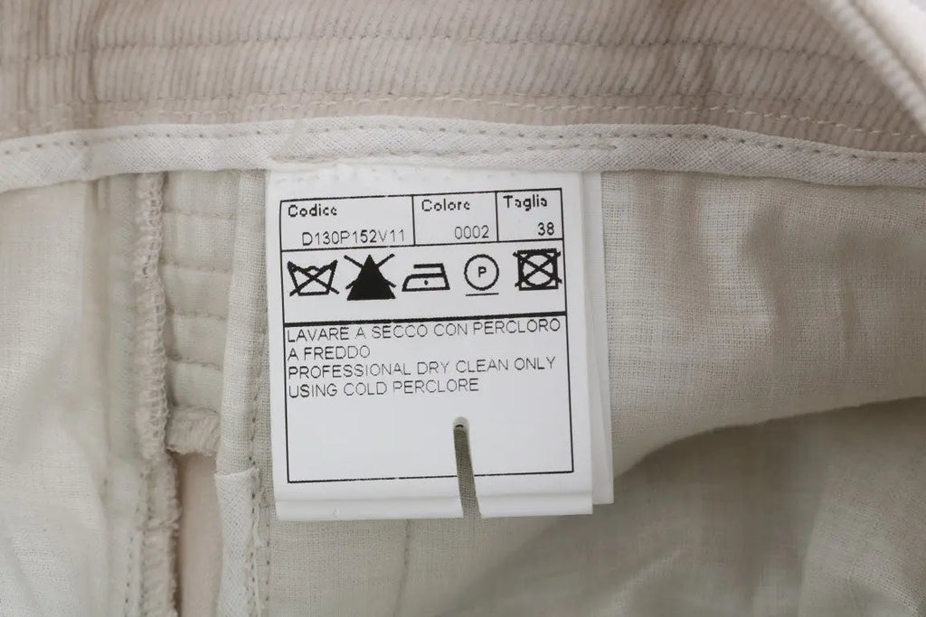 Beige slim-fit corduroy skinny pants with mid-rise waist and front pockets.