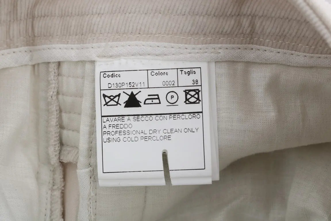 Beige slim-fit corduroy skinny pants with mid-rise waist and front pockets.