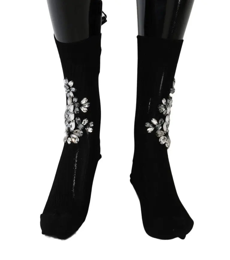 Black knitted socks with large clear crystal floral embellishments on the sides.