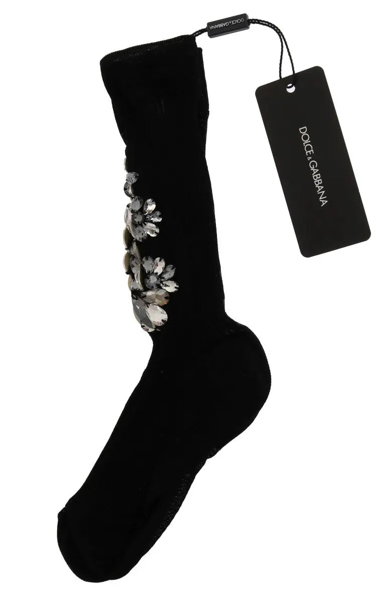 Black knitted socks with large clear crystal floral embellishments on the sides.