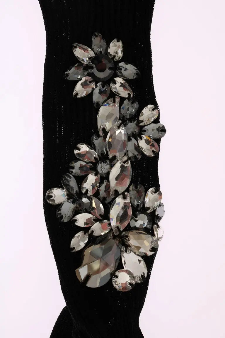 Black knitted socks with large clear crystal floral embellishments on the sides.
