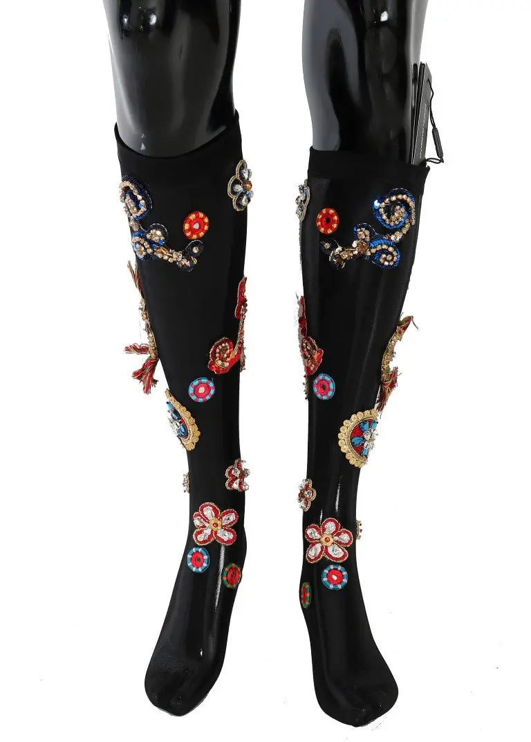 Black knee-high stretch socks with colorful crystal-embellished floral and paisley patterns.