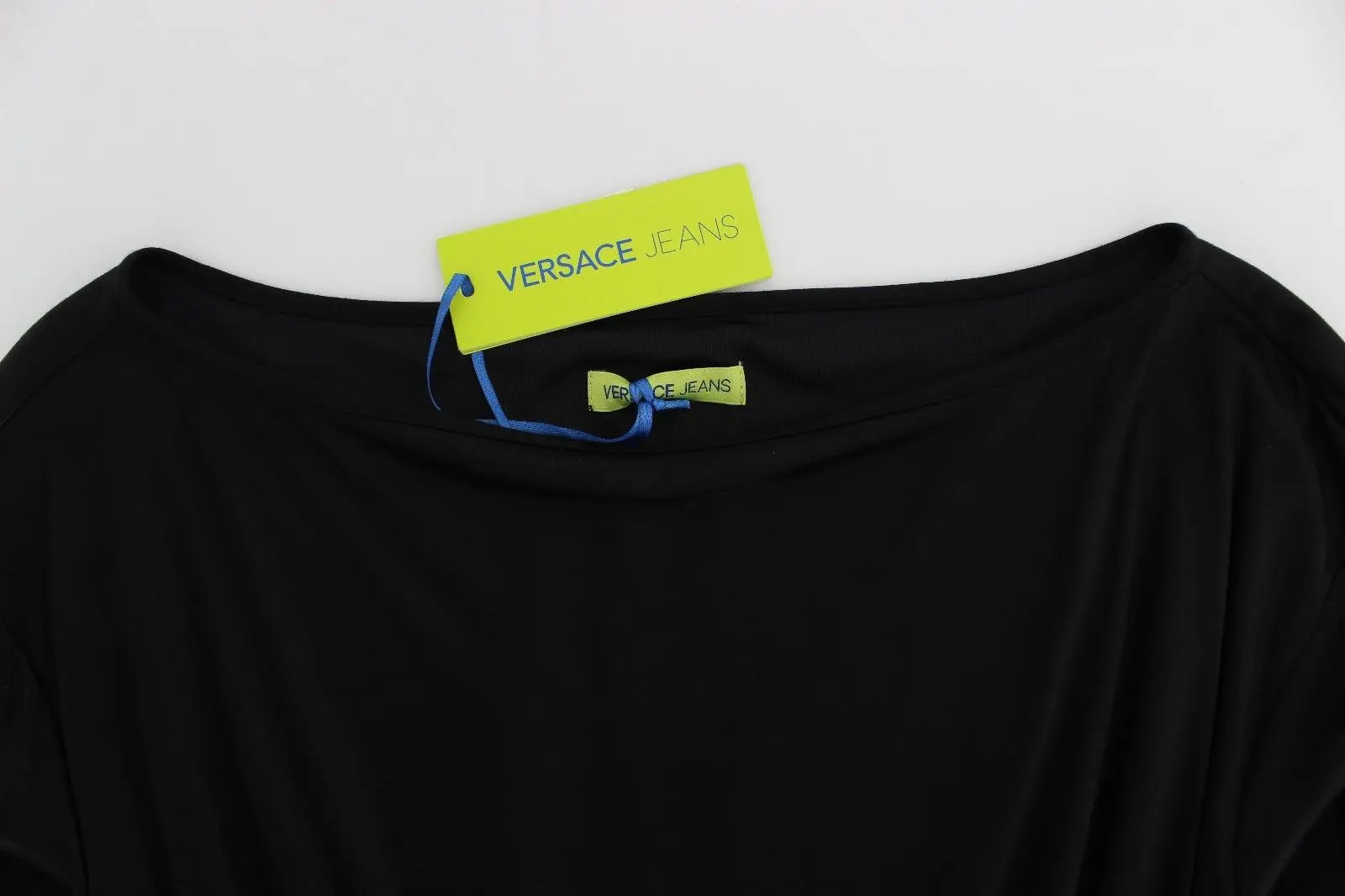 Black long-sleeve knee-length shift dress with boat neckline and drawstring waist.