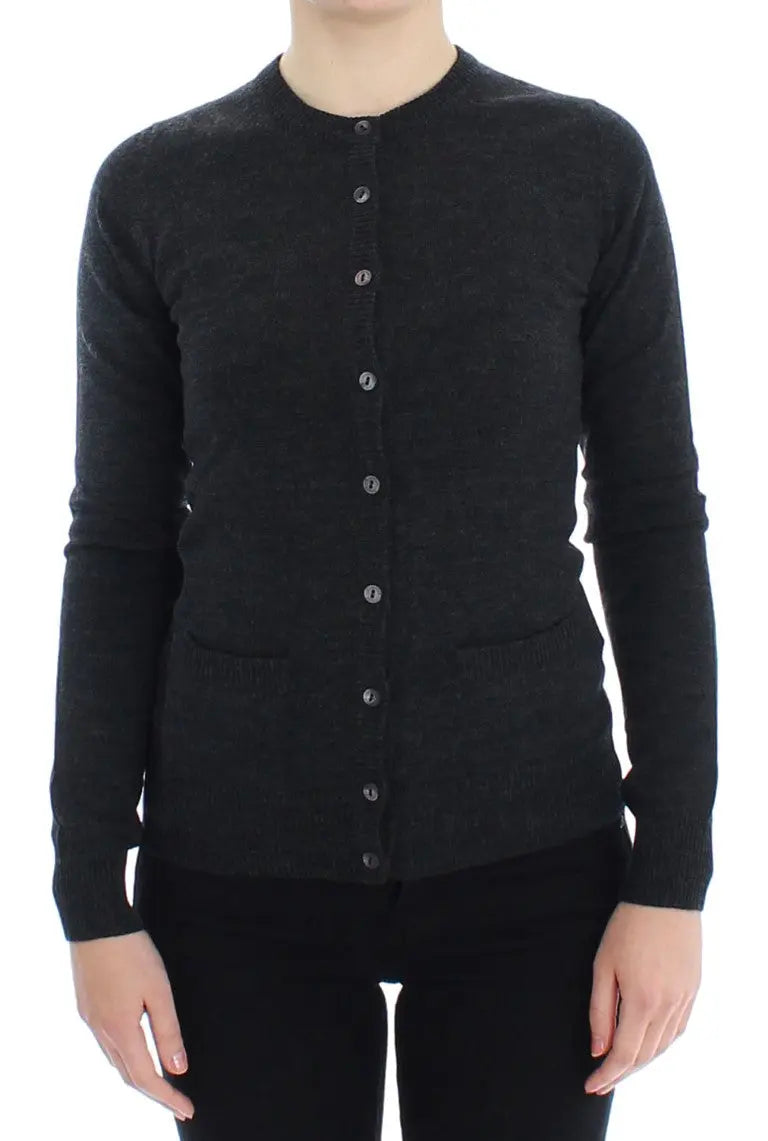 Dark gray wool button-up cardigan sweater with long sleeves and ribbed cuffs on a model.