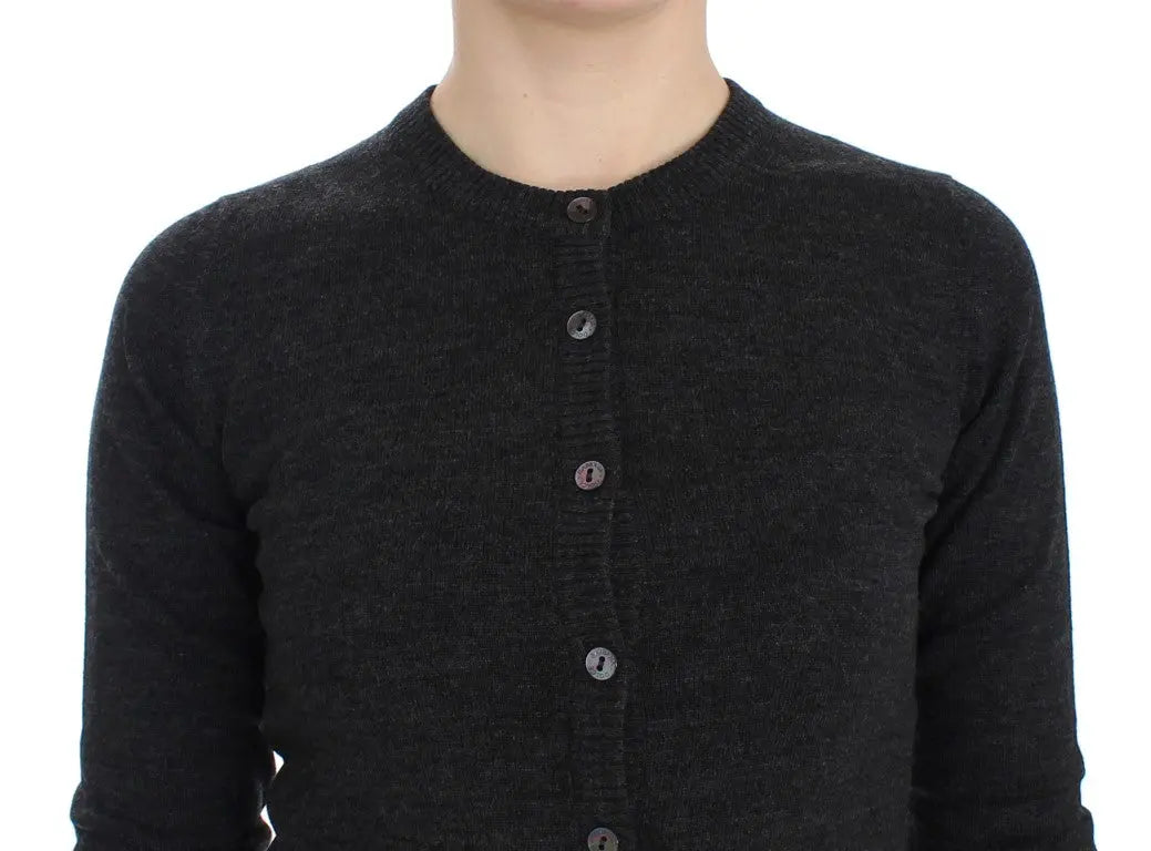 Dark gray wool button-up cardigan sweater with long sleeves and ribbed cuffs on a model.