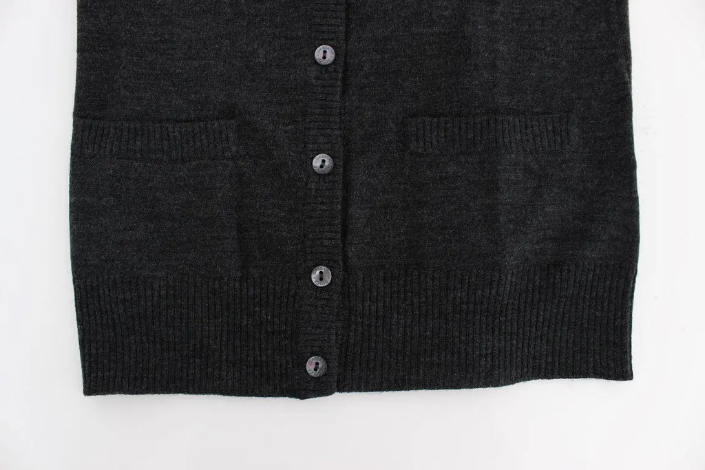 Dark gray wool button-up cardigan sweater with long sleeves and ribbed cuffs on a model.